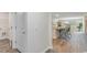 Open concept features a hall, kitchen with bar seating, and a glimpse into a dining area at 136 Ashworth Dr., Tabor City, NC 28463