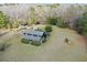 Aerial view showing the home, pool, detached garage, and mature trees at 1993 Meadowood Ln., Longs, SC 29568