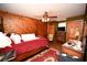 Spacious bedroom features a four-poster bed, wood-paneled walls, and a ceiling fan for added comfort at 1993 Meadowood Ln., Longs, SC 29568