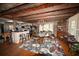 Open-concept dining area with hardwood floors, chandelier, and wooden beam ceilings at 1993 Meadowood Ln., Longs, SC 29568