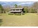 Exterior shot of home showing large front lawn and covered porch at 1993 Meadowood Ln., Longs, SC 29568