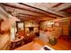Cozy living room with a brick fireplace, wooden walls, and beamed ceiling at 1993 Meadowood Ln., Longs, SC 29568