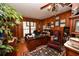 Traditional office with wood paneled walls, large desk, executive chair, and ornate chandelier at 1993 Meadowood Ln., Longs, SC 29568