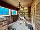 Enclosed patio features brick pillars, stained glass windows, a utility sink, and weathered wood paneling at 1993 Meadowood Ln., Longs, SC 29568