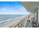 Relaxing balcony view of the ocean with chairs and tables for outdoor enjoyment at 2000 N Ocean Blvd. # 1601, Myrtle Beach, SC 29577