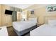 Bright bedroom featuring two beds, wall art, and bedside tables with lamps at 2000 N Ocean Blvd. # 1601, Myrtle Beach, SC 29577