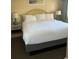 Bedroom featuring a king bed, bedside tables with lamps, and light yellow walls at 2000 N Ocean Blvd. # 1601, Myrtle Beach, SC 29577