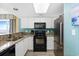 Bright kitchen features white cabinetry, stainless steel appliances, and granite countertops at 2000 N Ocean Blvd. # 1601, Myrtle Beach, SC 29577