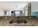 View from the kitchen featuring granite countertops that overlook the living area and outdoor balcony at 2000 N Ocean Blvd. # 1601, Myrtle Beach, SC 29577