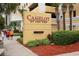 Exterior view of the 'Camelot By The Sea' sign features lush landscaping around it at 2000 N Ocean Blvd. # 1601, Myrtle Beach, SC 29577
