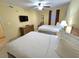 Comfortable bedroom with two beds, a dresser, and a ceiling fan for a relaxing and restful atmosphere at 2007 S Ocean Blvd. # 204, Myrtle Beach, SC 29577
