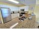 Bright, well-equipped kitchen featuring granite countertops, stainless appliances, and ample cabinet space at 2007 S Ocean Blvd. # 204, Myrtle Beach, SC 29577