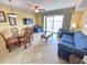 Inviting living room features tile floors, a ceiling fan, comfortable seating, and a glass door to a balcony at 2007 S Ocean Blvd. # 204, Myrtle Beach, SC 29577