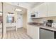 Bright kitchenette featuring tile flooring, white cabinetry, sink and appliances at 201 74Th Ave. N # 2941, Myrtle Beach, SC 29572