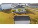 Aerial view of a backyard showcasing palm trees, a patio, and a storage shed at 2015 Borgata Loop, Longs, SC 29568