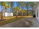 Landscaped backyard with palm trees, large patio, and a storage shed provides a private outdoor retreat at 2015 Borgata Loop, Longs, SC 29568