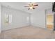 Bedroom with neutral carpet, ceiling fan, and plantation shutters for a bright and welcoming space at 2015 Borgata Loop, Longs, SC 29568