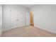 A bedroom featuring neutral carpeting, a double door closet, and a hallway door at 2015 Borgata Loop, Longs, SC 29568