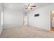 Bright and airy bedroom with neutral carpet, ceiling fan, and easy access to an ensuite bathroom at 2015 Borgata Loop, Longs, SC 29568