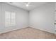 Well-lit bedroom with neutral carpet, ceiling fan, and window with plantation shutters at 2015 Borgata Loop, Longs, SC 29568