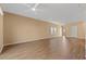 Large living room with ceiling fan, neutral walls, wood floors, and access to the outdoors at 2015 Borgata Loop, Longs, SC 29568