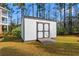 White wooden shed with double doors on a well-maintained lawn at 2015 Borgata Loop, Longs, SC 29568