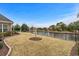 Picturesque backyard featuring a pond, well-maintained lawn, and privacy with perimeter fence at 205 Deep Blue Dr., Myrtle Beach, SC 29579