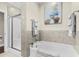 This bathroom features a bathtub, shower with glass door, neutral colored walls, and a painting at 205 Deep Blue Dr., Myrtle Beach, SC 29579