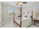 This is a simple bedroom featuring a four poster bed, neutral walls, carpet, and a ceiling fan at 205 Deep Blue Dr., Myrtle Beach, SC 29579
