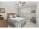 Cozy bedroom with neutral paint, a ceiling fan, carpet, and a window with a view of the backyard at 205 Deep Blue Dr., Myrtle Beach, SC 29579