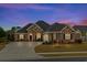Charming brick home featuring a red door, manicured lawn, and a welcoming curb appeal at 205 Deep Blue Dr., Myrtle Beach, SC 29579