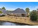 Charming home exterior with a fenced-in backyard, waterfront view, and covered patio at 205 Deep Blue Dr., Myrtle Beach, SC 29579