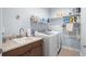 Well organized laundry room with front load washer, dryer, sink, and ample storage shelves at 205 Deep Blue Dr., Myrtle Beach, SC 29579