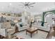 Open-concept living room with abundant natural light, neutral furniture, and a view into kitchen at 205 Deep Blue Dr., Myrtle Beach, SC 29579