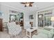 Comfortable living room connects to the sunroom with light green walls and lots of natural light at 205 Deep Blue Dr., Myrtle Beach, SC 29579