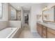 Luxurious main bathroom featuring a soaking tub, walk-in shower, and double vanity with granite countertops at 205 Deep Blue Dr., Myrtle Beach, SC 29579