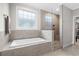 Elegant bathroom featuring a soaking tub and tiled walk-in shower at 205 Deep Blue Dr., Myrtle Beach, SC 29579