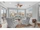 Cozy sunroom with comfortable seating, a ceiling fan, and sliding glass doors to the outside at 205 Deep Blue Dr., Myrtle Beach, SC 29579