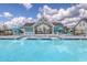 Community pool with covered lounge area, surrounded by comfortable blue lounge chairs at 206 Portofino Dr., Myrtle Beach, SC 29579