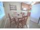 Cozy dining area with wood table, four chairs, and kitchen view at 210 25Th Ave. S # 26, Myrtle Beach, SC 29577