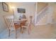 Cozy dining area featuring a round wooden table and chairs near the staircase at 210 25Th Ave. S # 26, Myrtle Beach, SC 29577