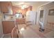 Functional kitchen features wood cabinets, white appliances, and a cozy dining area at 210 25Th Ave. S # 26, Myrtle Beach, SC 29577