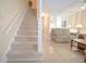 Bright living area with staircase, comfy sofa, coffee table, and tile flooring at 210 25Th Ave. S # 26, Myrtle Beach, SC 29577