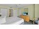 Bright bedroom featuring a plush queen bed, TV, and convenient closet space at 2201 S Ocean Blvd. # 1806, Myrtle Beach, SC 29577