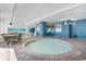 Indoor hot tub with tables and chairs surrounding it, under a bright white ceiling and walls at 2201 S Ocean Blvd. # 1806, Myrtle Beach, SC 29577