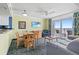 Living area with dining table and balcony, offering a cozy and bright space at 2201 S Ocean Blvd. # 1806, Myrtle Beach, SC 29577