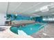The bright and cheery indoor pool has a beach mural and lounge chairs, next to tables and chairs at 2201 S Ocean Blvd. # 1806, Myrtle Beach, SC 29577