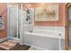 Bright bathroom showcasing a shower and soaking tub with neutral tile and a large decorative painting at 2304 Pointe Marsh Ln., North Myrtle Beach, SC 29582