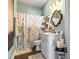 Cozy bathroom with a decorative mirror, white vanity, and a leaf-patterned shower curtain at 2304 Pointe Marsh Ln., North Myrtle Beach, SC 29582