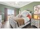 Serene bedroom featuring a large window with a view and a beautifully decorated bed at 2304 Pointe Marsh Ln., North Myrtle Beach, SC 29582